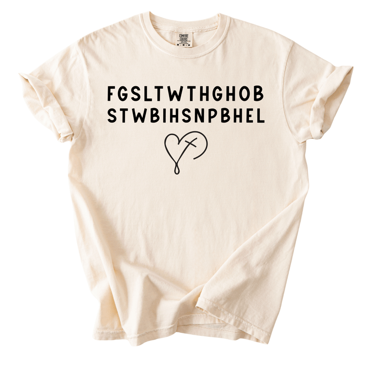 A cream-colored t-shirt with the text "FGSLTHGOB STWBHSNPBHL" printed on it.