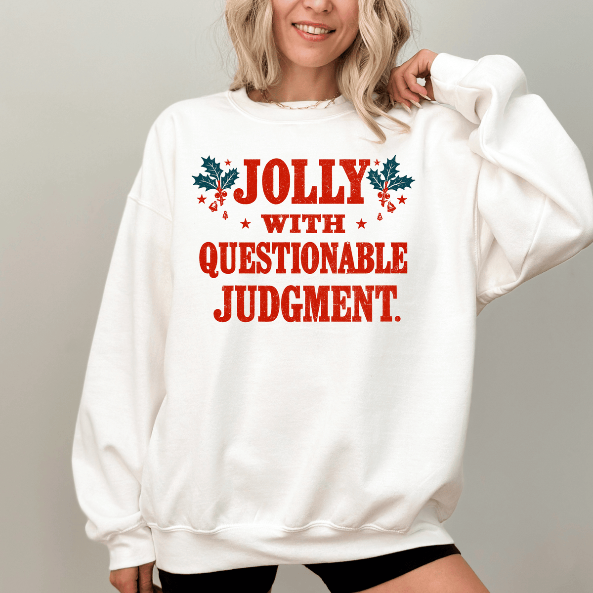 A woman wearing a white sweatshirt with the text "Jolly with Questionable Judgment" printed on it.