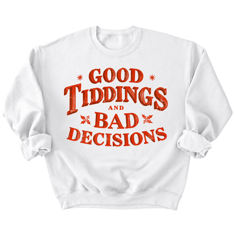 A white sweatshirt with the text "GOOD TIDDINGS AND BAD DECISIONS" printed on it in a red and orange color scheme.