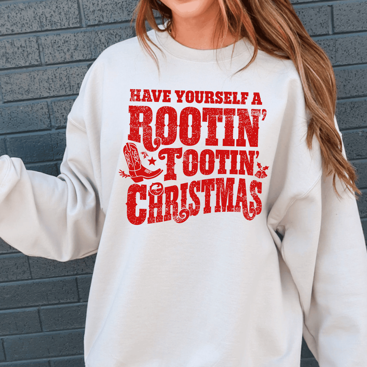A white sweatshirt with a red text design that says "Have Yourself a Rootin' Tootin' Christmas".