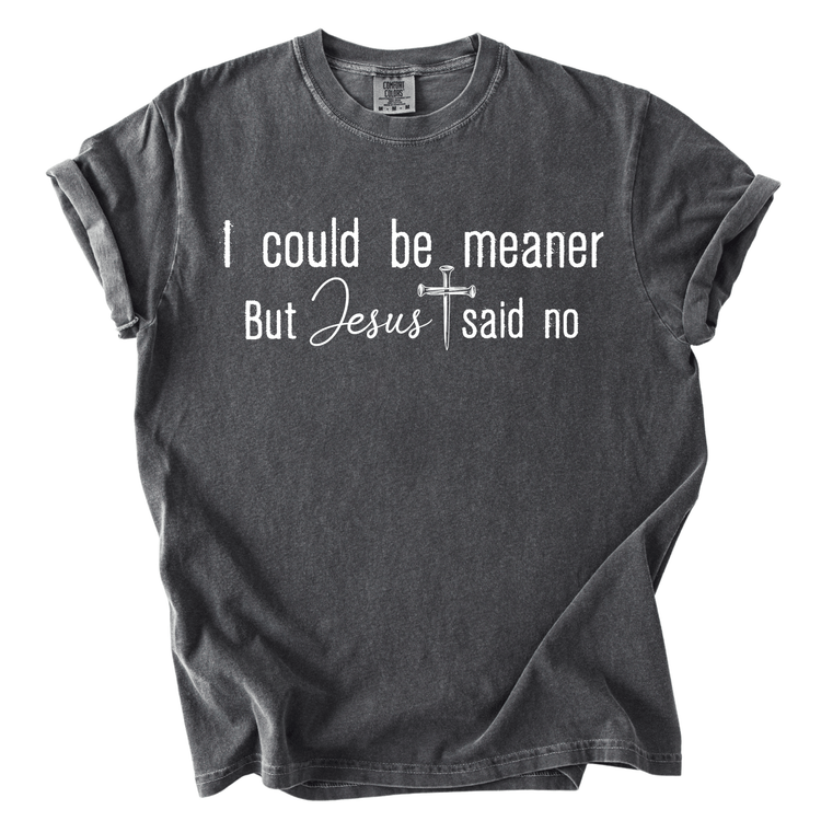 A gray t-shirt with the text "I could be meaner But Jesus said no" printed on it.