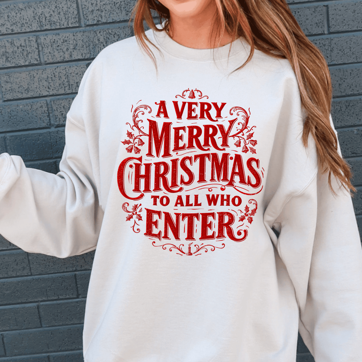 A white sweatshirt with a red and black text design that reads "A Very Merry Christmas to All Who Enter".