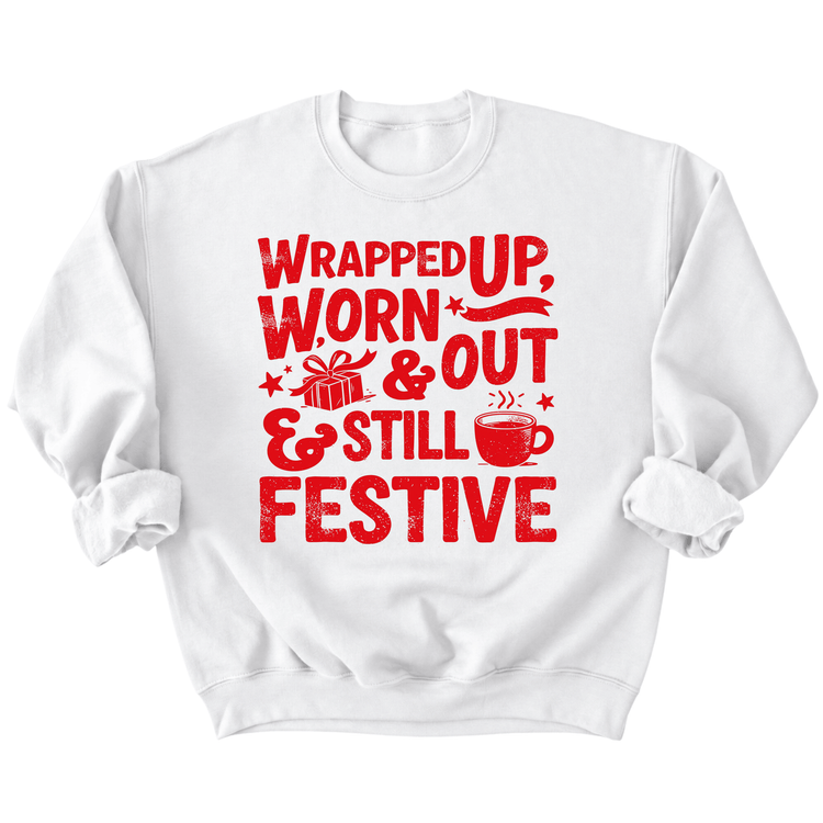 A white sweatshirt with a red graphic design featuring text that reads "Wrapped up, worn & out & still festive".