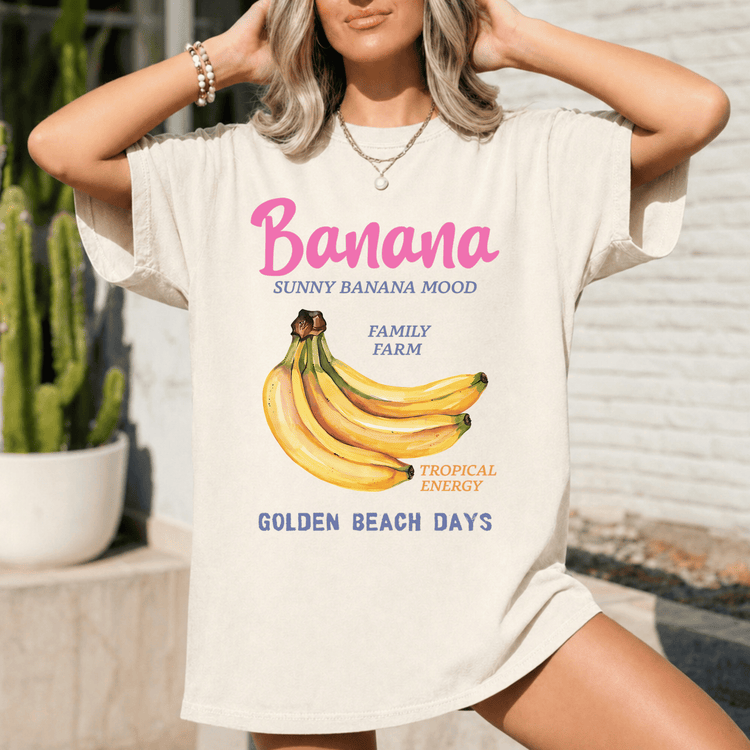 A woman wearing a white t-shirt with a graphic design of bananas and text related to bananas.