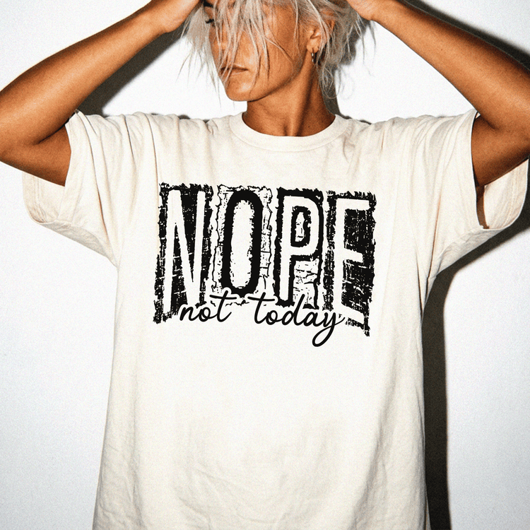 A person wearing a white t-shirt with the text "NOPE not today" printed on it.