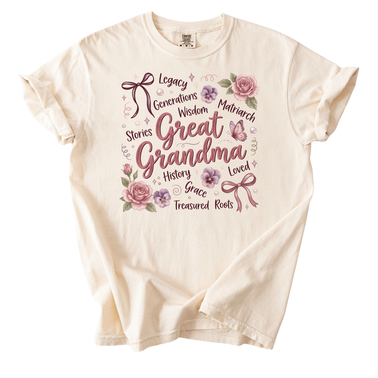 The image is a white t-shirt with a printed design that includes the words "Great Grandma" surrounded by various floral elements and decorative elements.