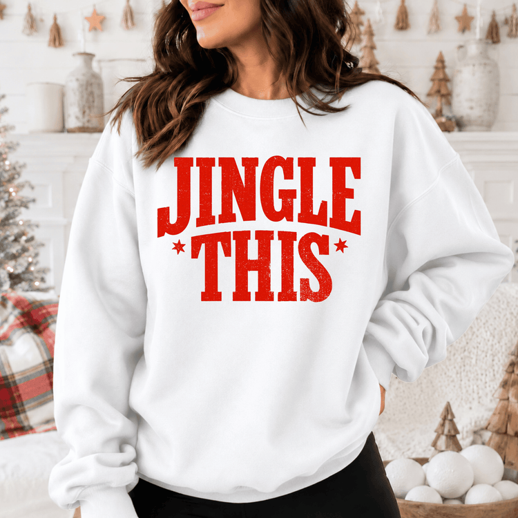 A woman wearing a white sweatshirt with the text "JINGLE THIS" printed on it.