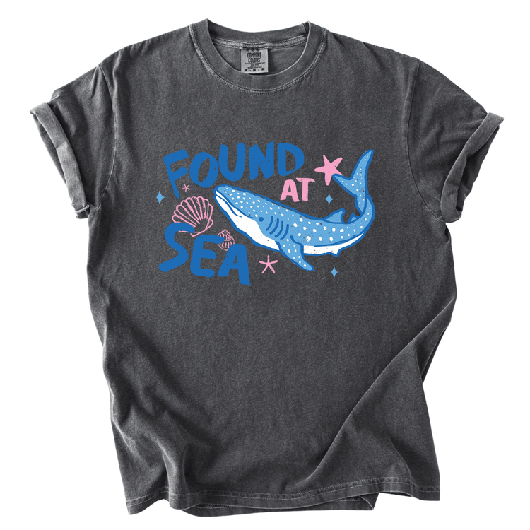 a gray t-shirt with a graphic design depicting a blue whale and various marine elements, including a starfish and seashells.